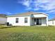 Backyard featuring a sliding glass door and covered patio at 1077 Chelan Falls N Trl, Deland, FL 32724