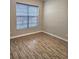 Bedroom with wood-look floors and a window with blinds at 1077 Chelan Falls N Trl, Deland, FL 32724