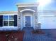 Charming home featuring a stone front facade, two-car garage, and landscaped yard at 1077 Chelan Falls N Trl, Deland, FL 32724