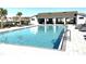 A spacious community pool with lounge chairs and covered seating for relaxation at 1077 Chelan Falls N Trl, Deland, FL 32724