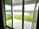 Sliding glass doors opening to a beautiful backyard view of the lake and landscape at 1077 Chelan Falls N Trl, Deland, FL 32724