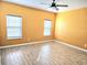 Spacious bedroom featuring modern flooring, two windows providing natural light, and neutral walls at 1077 Chelan Falls N Trl, Deland, FL 32724