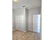 This bedroom features wood-look flooring and a closet with white bi-fold doors at 1077 Chelan Falls N Trl, Deland, FL 32724