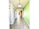 Hallway with wood-look tile floors leading to the living areas at 1077 Chelan Falls N Trl, Deland, FL 32724