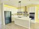 Bright kitchen with white cabinets, stainless steel appliances, center island, and decorative backsplash at 1077 Chelan Falls N Trl, Deland, FL 32724