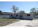 Lovely single-story home featuring a spacious driveway and cozy front porch at 1103 Malcom Rd, Ocoee, FL 34761