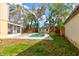 Private backyard features a swimming pool, shed, and wood fence at 1118 Meditation Loop, Port Orange, FL 32129