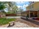 Backyard view with a pool, shed, screened-in porch, and yellow house at 1118 Meditation Loop, Port Orange, FL 32129
