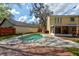 Backyard pool with a wooden shed and yellow two-story house at 1118 Meditation Loop, Port Orange, FL 32129
