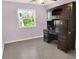 Bright bedroom with a large desk, natural light, and tiled floors at 1118 Meditation Loop, Port Orange, FL 32129