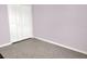 A bedroom with gray tile flooring, lilac walls, and bi-fold closet doors at 1118 Meditation Loop, Port Orange, FL 32129