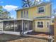 The back of the house has a closed porch area and a well landscaped flower bed at 1118 Meditation Loop, Port Orange, FL 32129