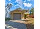 Inviting home featuring a gray garage door, complemented by a well-maintained lawn at 1118 Meditation Loop, Port Orange, FL 32129