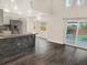 Well-lit kitchen features stainless appliances, breakfast bar, and access to a patio at 1118 Meditation Loop, Port Orange, FL 32129