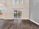 Bright living space featuring wood floors and sliding glass doors leading to the patio at 1118 Meditation Loop, Port Orange, FL 32129
