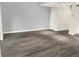 Spacious living area featuring wood-look floors, neutral paint, and bright track lighting at 1118 Meditation Loop, Port Orange, FL 32129