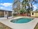 The pool features a concrete surround, a storage shed and a grill at 1118 Meditation Loop, Port Orange, FL 32129