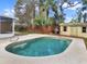 Backyard pool with a wooden shed and grill on a sunny day at 1118 Meditation Loop, Port Orange, FL 32129