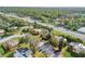 Aerial view of community featuring a community pool, mature trees, and convenient location at 116 Moonstone Ct, Port Orange, FL 32129