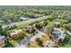 Aerial view of the neighborhood with mature trees, community parking, and well-maintained landscaping at 116 Moonstone Ct, Port Orange, FL 32129