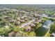Aerial view of the community featuring mature trees, pond, and convenient location at 116 Moonstone Ct, Port Orange, FL 32129