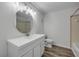 Bright bathroom features a white vanity, modern fixtures, and wood look flooring at 116 Moonstone Ct, Port Orange, FL 32129