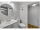 Bathroom featuring a toilet, sink, mirror, and doorway with decorative floor tiles at 116 Moonstone Ct, Port Orange, FL 32129