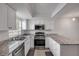 Bright kitchen with granite countertops, stainless steel appliances, and white cabinets at 116 Moonstone Ct, Port Orange, FL 32129