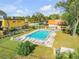 Community pool surrounded by lounge chairs and lush landscaping at 116 Moonstone Ct, Port Orange, FL 32129
