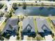This is an aerial view of the houses that surround the pond, and neighborhood roads at 1204 Draycott St, Ormond Beach, FL 32174