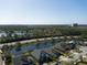 A high altitude view showing multiple houses along a river with trees and a building in the background at 1204 Draycott St, Ormond Beach, FL 32174