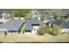Aerial view of a well-maintained home featuring a large backyard with direct access to a serene lake at 1204 Draycott St, Ormond Beach, FL 32174
