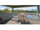 Outdoor seating on a balcony overlooking a peaceful water view at 1204 Draycott St, Ormond Beach, FL 32174