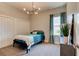 Simple bedroom with blue accents, a modern light fixture, and bright natural light at 1204 Draycott St, Ormond Beach, FL 32174