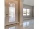 Bright entryway with marble flooring, a leaded glass door, and a view into a front room at 1204 Draycott St, Ormond Beach, FL 32174