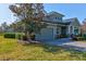 This property features a two-car garage, a beautifully landscaped yard, and a charming facade at 1204 Draycott St, Ormond Beach, FL 32174