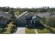 Beautiful home exterior featuring lush landscaping, a spacious driveway, and serene water view at 1204 Draycott St, Ormond Beach, FL 32174