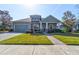 Charming single-Gathering home with well-manicured lawn, lush landscaping, and a two-car garage at 1204 Draycott St, Ormond Beach, FL 32174