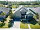 Stunning lakefront home with a three-car garage, paver driveway, and manicured landscaping at 1204 Draycott St, Ormond Beach, FL 32174