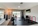 Spacious home gym with a variety of exercise equipment and a mirrored wall at 1204 Draycott St, Ormond Beach, FL 32174