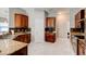 An eat-in kitchen featuring granite countertops, wood cabinets, tile backsplash and stainless steel sink at 1204 Draycott St, Ormond Beach, FL 32174
