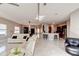 Open concept living area with modern kitchen and dining space, featuring sleek tile floors at 1204 Draycott St, Ormond Beach, FL 32174