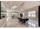 Spacious living room with a dining area, large windows, and modern lighting fixtures at 1204 Draycott St, Ormond Beach, FL 32174