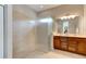 The spacious main bathroom features a walk-in shower and double vanity sinks at 1204 Draycott St, Ormond Beach, FL 32174