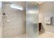 Walk-in shower features shower head, frosted glass and tile surround at 1204 Draycott St, Ormond Beach, FL 32174