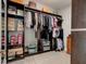 The walk-in closet features wood shelving for clothes and accessories in a neutral space at 1204 Draycott St, Ormond Beach, FL 32174
