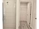 Modern bathroom features a glass-enclosed shower with vertical tiling and access to a walk-in closet at 1275 16Th St, Orange City, FL 32763