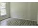 Cozy bedroom with natural light, wood-look floors, and neutral walls at 1275 16Th St, Orange City, FL 32763