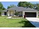 Charming single-story home featuring a well-manicured lawn, inviting entryway, and a spacious two-car garage at 1275 16Th St, Orange City, FL 32763