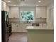 Open kitchen featuring stainless appliances, white cabinets and light countertops at 1275 16Th St, Orange City, FL 32763